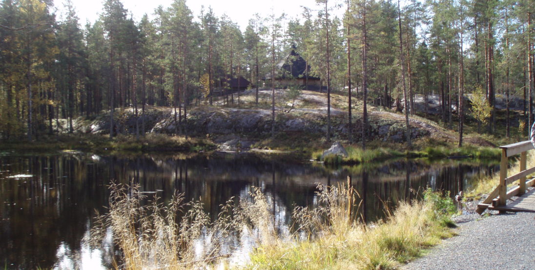 Metsälampi elämysliikuntareitti. Reitti kulkee Metsälammen yli sillan päältä. Taustalla metsä, kalliota ja kota
